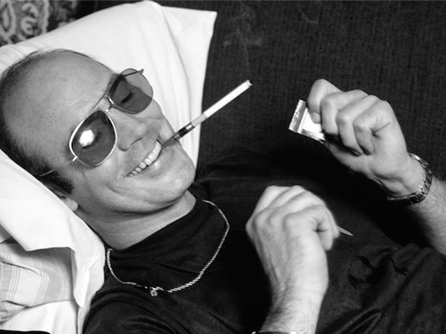 1977-hunter-thompson-lying-on-couch-smoking-and-smiling-gramercy-hotel-2-edit